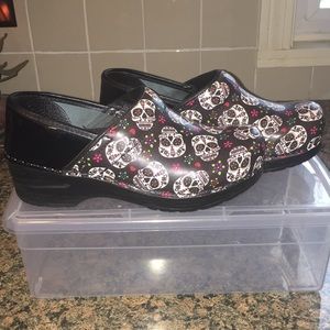Women’s Sanita black patent sugar skull clogs.